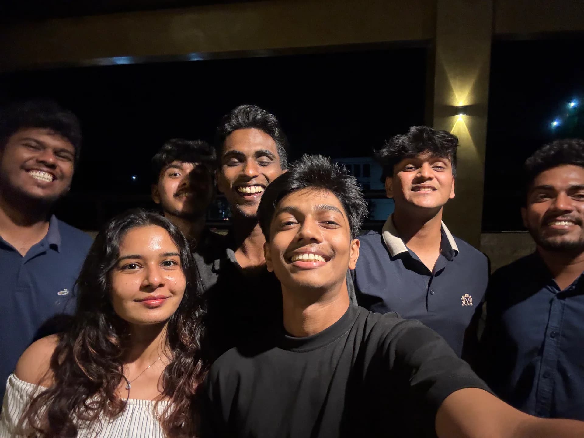 D15 Labs team smiling together in a group selfie at night